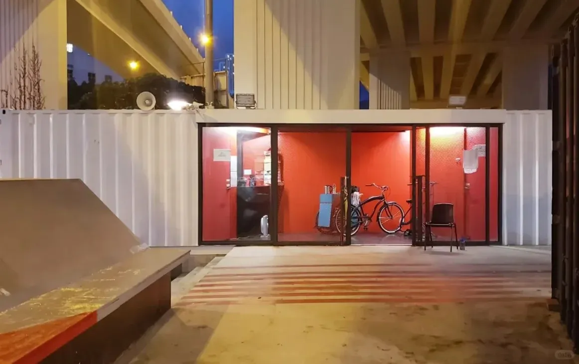 Earlier completed phase with white containers and red interior beneath the flyover