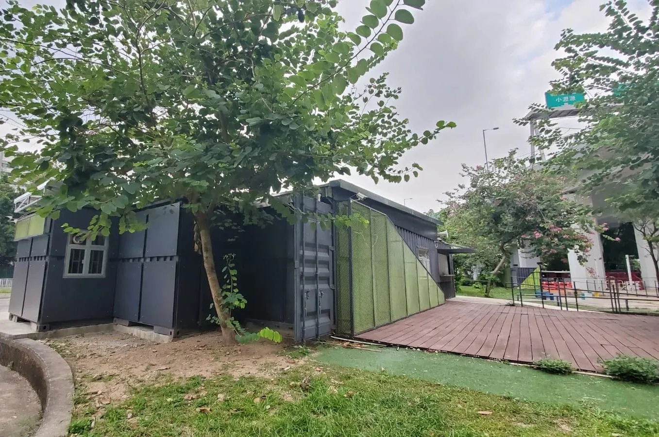 Side view of Sha Lek Corner with green perforated screens and outdoor deck